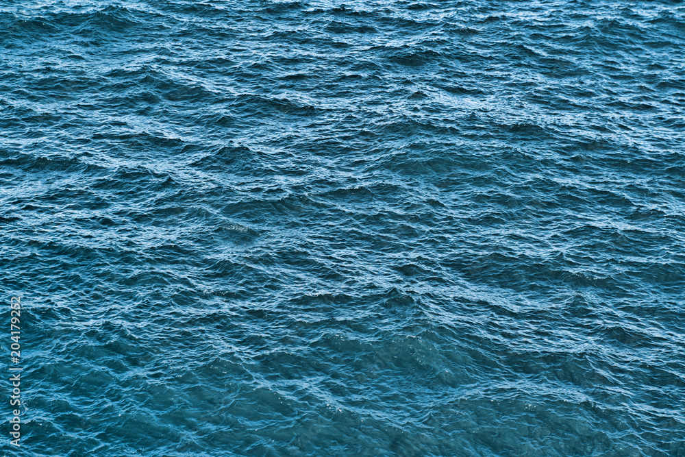Obraz premium Water background texture. Sea surface in sunset light