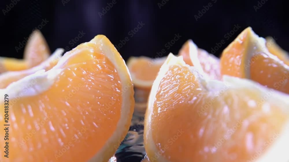 Orange splits into halves on water. Slow motion shot Orange splits into halves on water. Slow motion shot