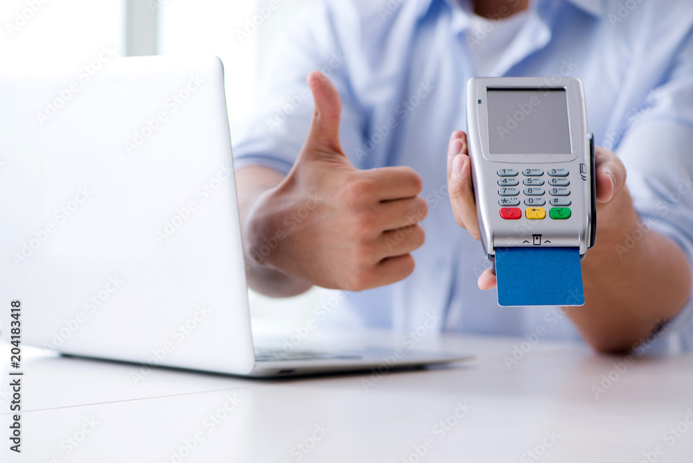 Man processing credit card transaction with POS terminal Man processing credit card transaction with POS terminal