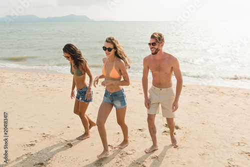 Group of friends at tropical summer beach on holidays