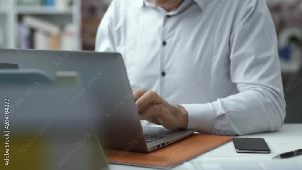Corporate businessman having a phone call in the office Corporate businessman having a phone call in the office