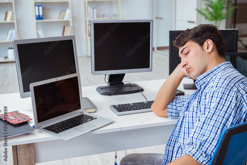 Businessman sitting in front of many screens Businessman sitting in front of many screens