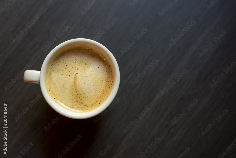 Cup of coffee on a wooden background. Kind from above. Cup of coffee on a wooden background. Kind from above.