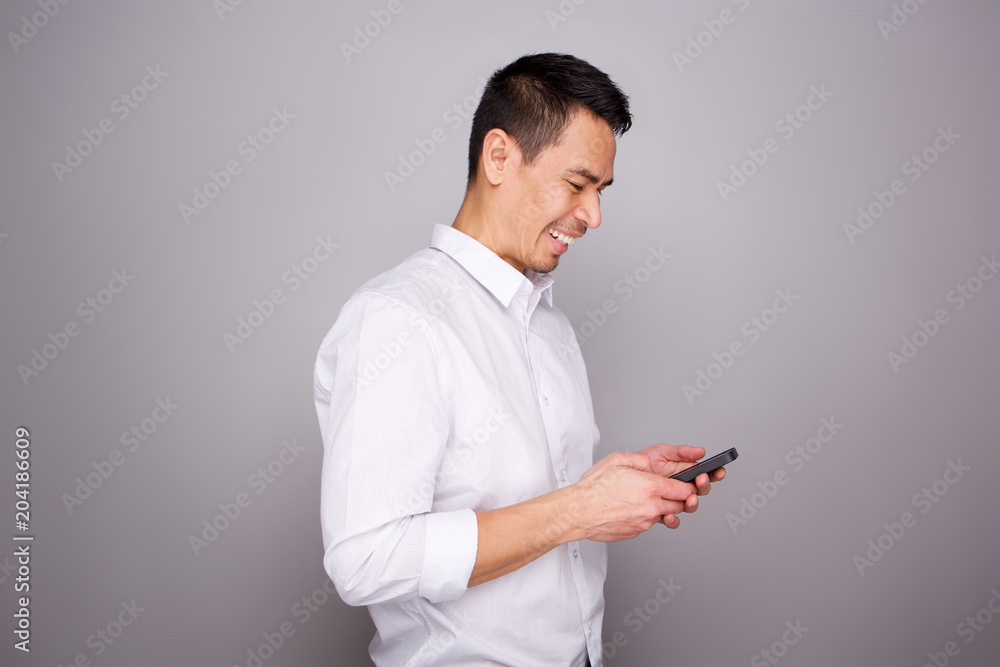 Mature man smiling with a mobile phone Mature man smiling with a mobile phone