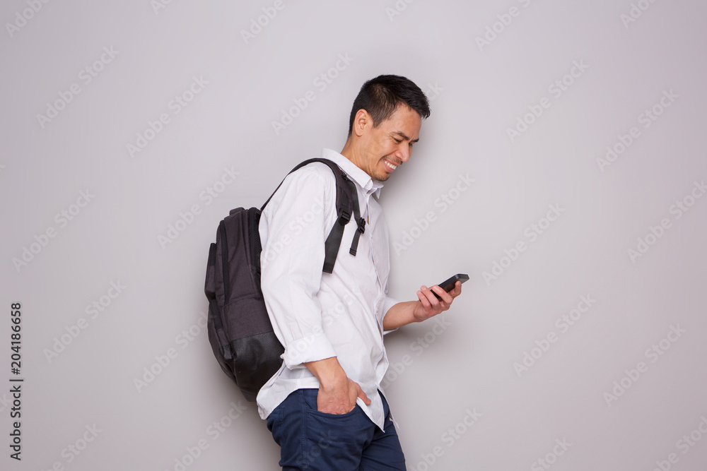 Relaxed older man with bag and mobile phone Relaxed older man with bag and mobile phone