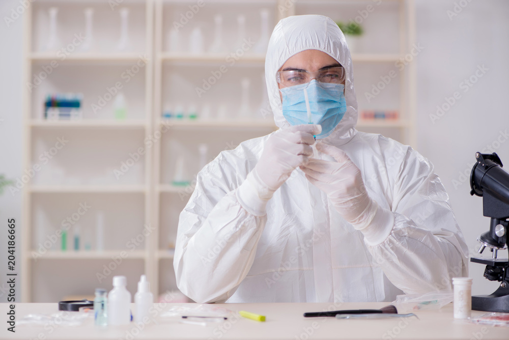 Expert criminologist working in the lab for evidence Expert criminologist working in the lab for evidence