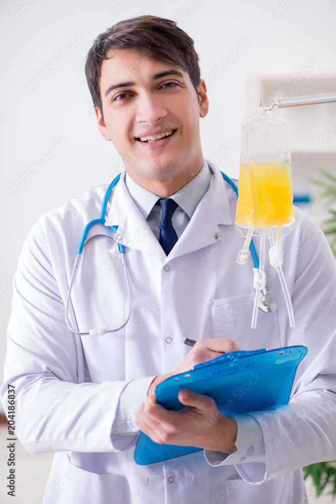 Doctor with bag of blood plasma in hospital Doctor with bag of blood plasma in hospital