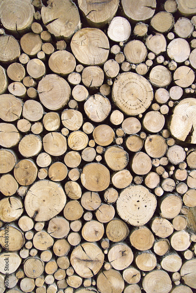 Sawn timber logs stacked for a wood burning stove. Close up in full frame and a vertical format Sawn timber logs stacked for a wood burning stove. Close up in full frame and a vertical format