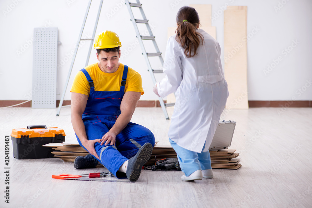 Worker with injured leg and doctor Worker with injured leg and doctor