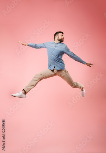 Full length of a joyful young man jumping