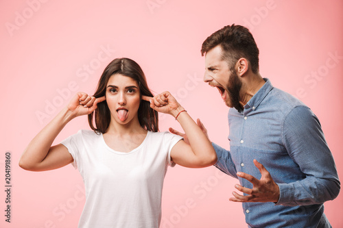 Portrait of an angry young couple having an argument photo