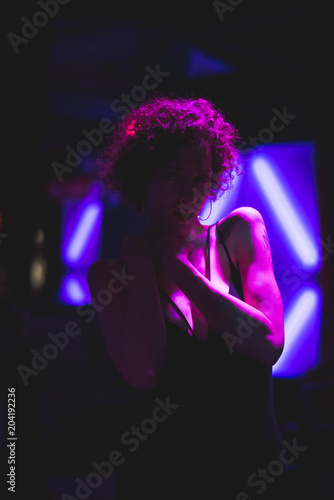 Portrait of a woman in a dark bar