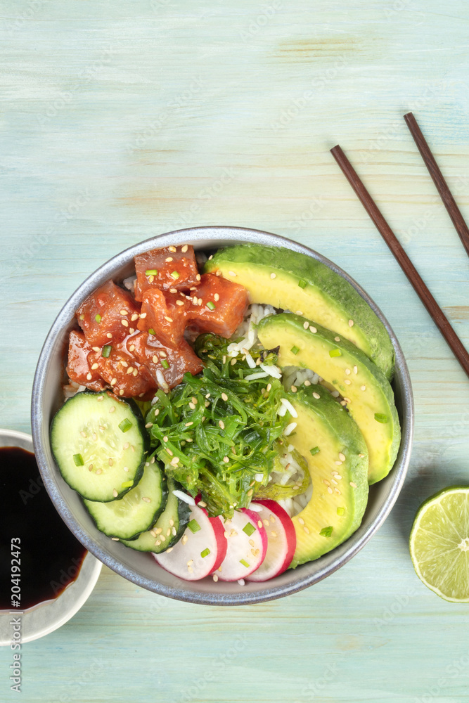 Closeup of Hawaiian tuna poke salad on teal with copy space Closeup of Hawaiian tuna poke salad on teal with copy space
