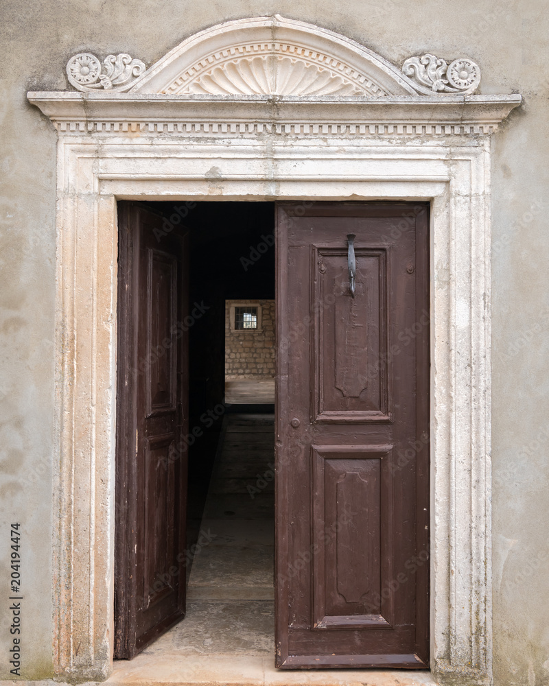 Open door and alley of a monastery in Croatia