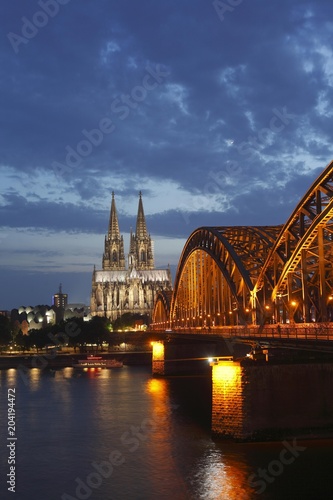 Cologne Cathedral with Hohenzollern Bridge at dusk, Cologne, North Rhine-Westphalia, Germany, Europe photo