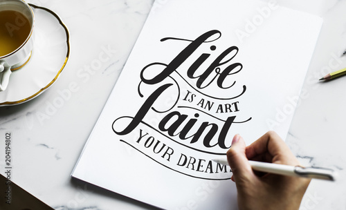 An artist creating hand lettering artwork photo