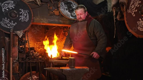 The smith viking working hard in a smithy