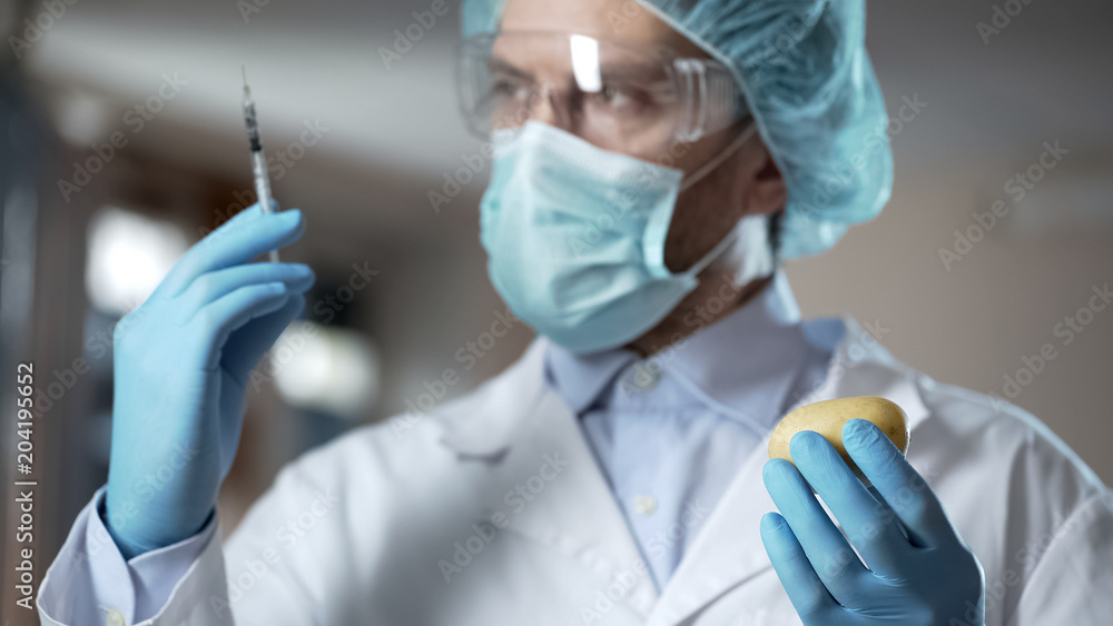 Scientist preparing syringe for adding pesticides and nitrates in potato sample Scientist preparing syringe for adding pesticides and nitrates in potato sample