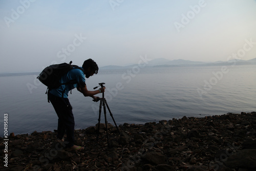 Canvas Print Silhouette of the photographer with tripod