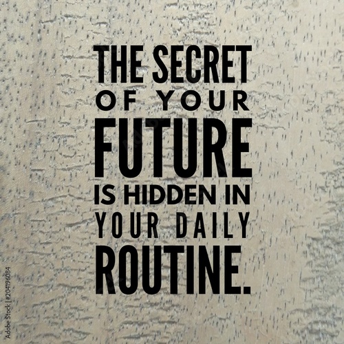 Motivational quote "The secret of your future is hidden in your daily routine." on a wooden background.
