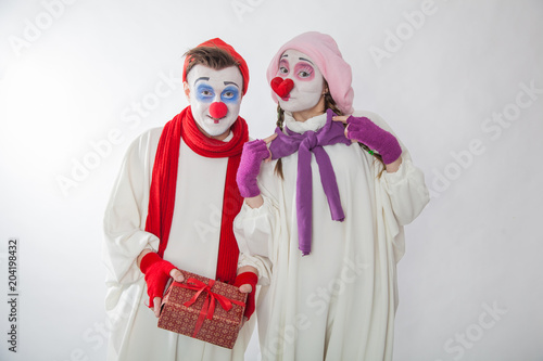 emotional mime guy and girl holding a gift. Human emotions: greed, joy and curiosity
