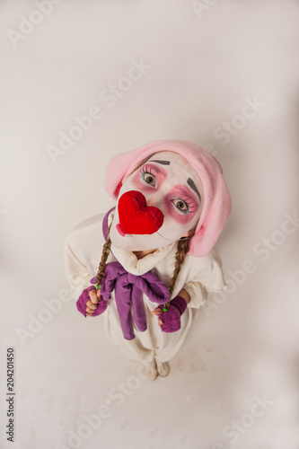 emotional girl funny posing at the camera. Human emotions in the image of a clown