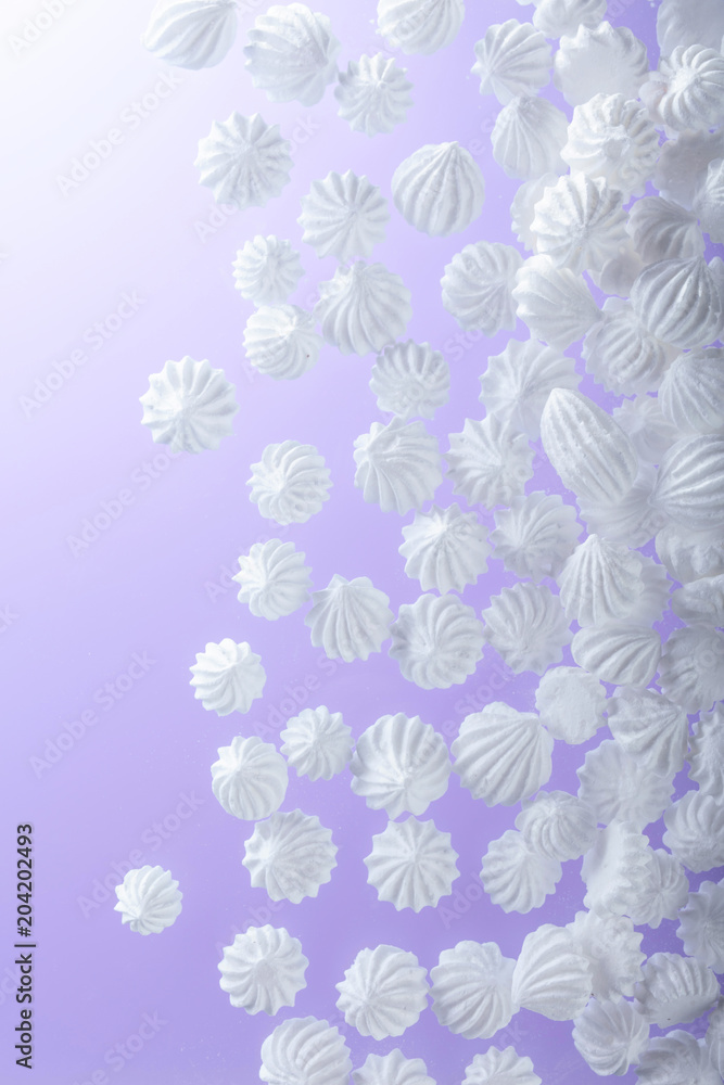 French vanilla meringue cookies on purple background with copy space.