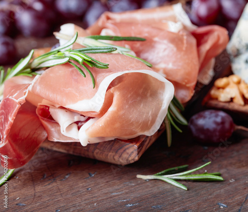 Prosciutto with grapes and rosemary  .