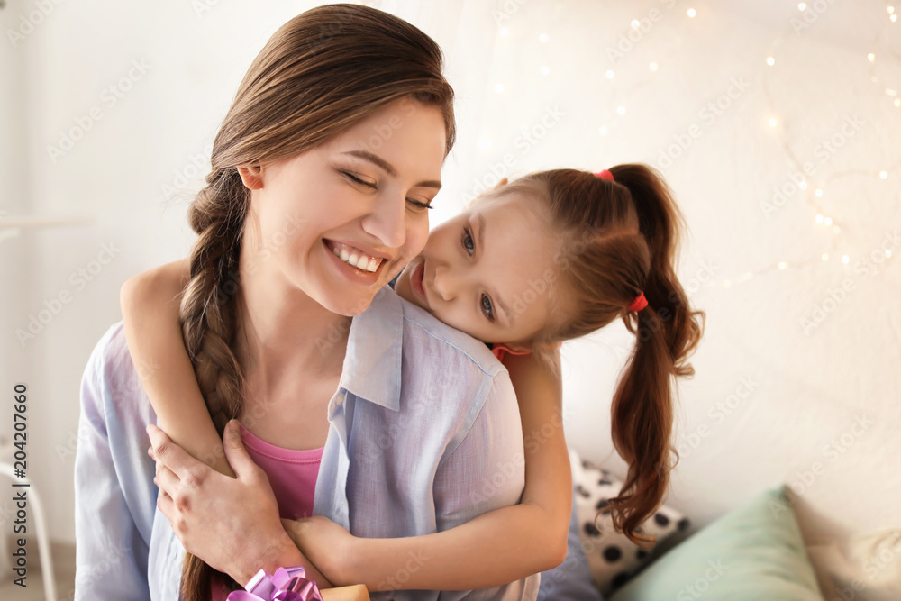 Portrait of mother and cute little daughter at home Portrait of mother and cute little daughter at home