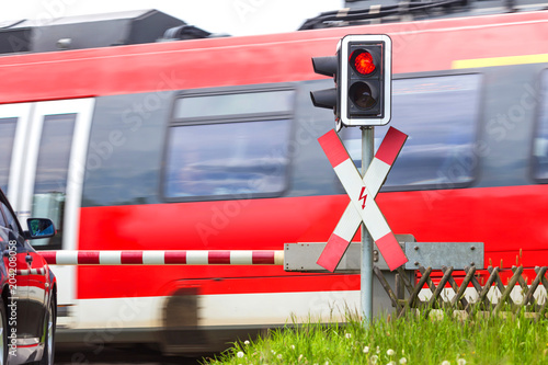 closed railroad crossing with passing train