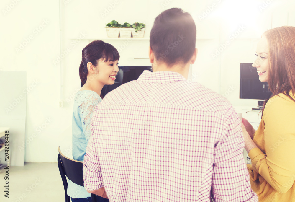 business, communication, startup and people concept - happy creative team or students talking and drinking coffee at office business, communication, startup and people concept - happy creative team or students talking and drinking coffee at office