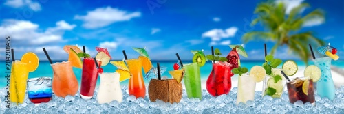 various colorful cocktails in crushed ice cubes isolated on palm beach backround beverages alcoholic drinks panorama banner photo