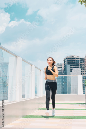 Young asian woman in sport wear doing sports outdoors