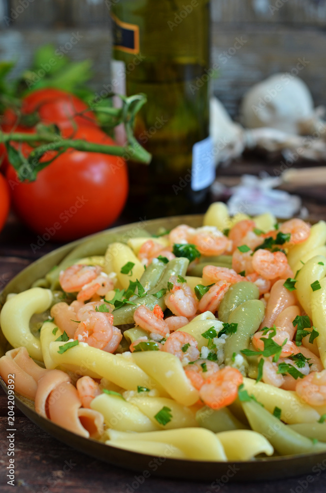 Fried prawns on wine with pasta in a pan