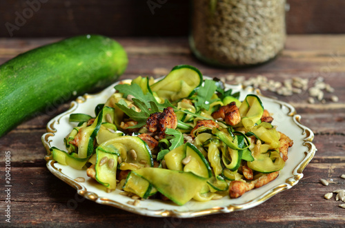 Zucchini with chicken sprinkled with sunflower seeds