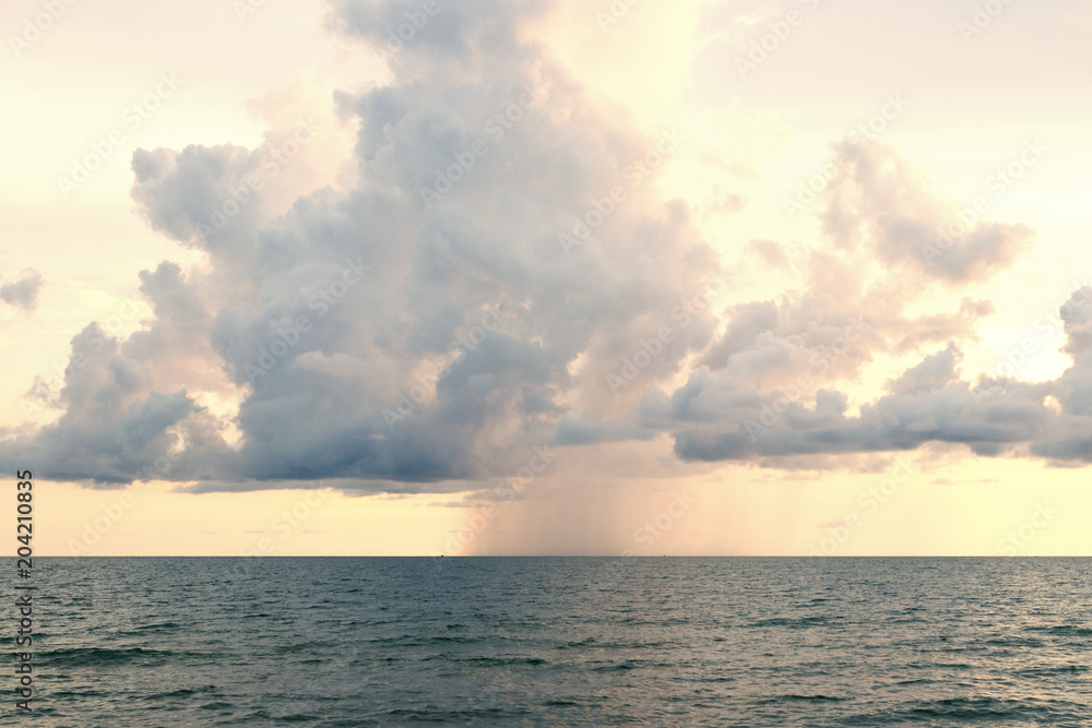 Rain with clouds over sea.