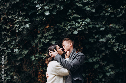 Fashion engagement shooting, photo session for beautiful couple, walk of a couple in love around the city and park.