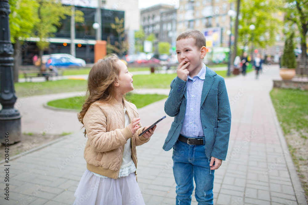 Group portrait of two white Caucasian cute adorable funny children talking smiling. Love friendship fun concept. Small adults Group portrait of two white Caucasian cute adorable funny children talking smiling. Love friendship fun concept. Small adults