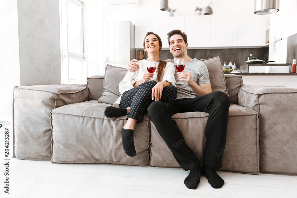 Portrait of a happy young couple relaxing on a couch Portrait of a happy young couple relaxing on a couch