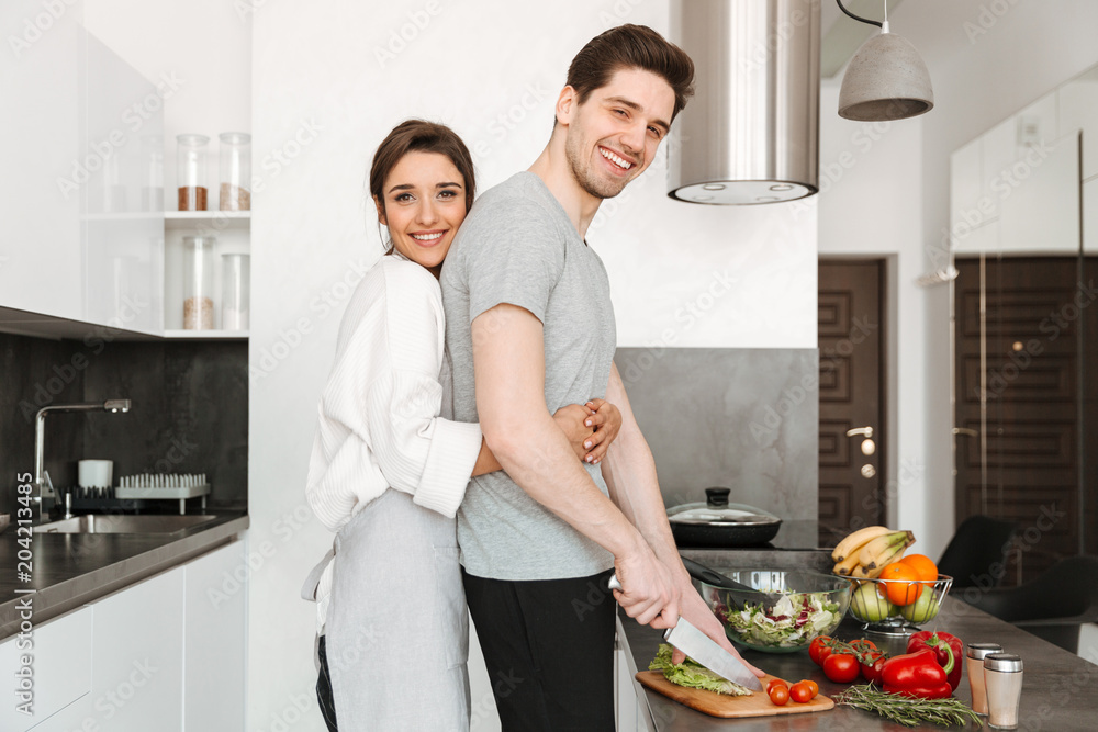 Portrait of a loving young couple cooking together Portrait of a loving young couple cooking together