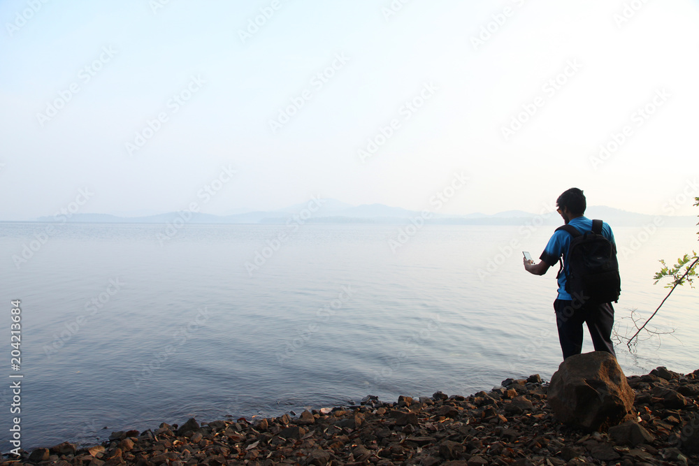 A man takes selfie photo in the morning near lake in india A man takes selfie photo in the morning near lake in india
