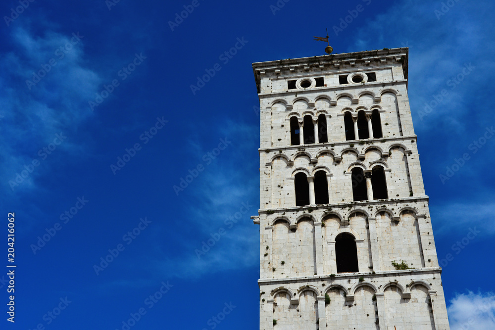 Saint Micheal in Foro Church medieval romanesque bell tower, erected in the 13th century  in the city of Lucca, Tuscany (with blue sky and copy space)