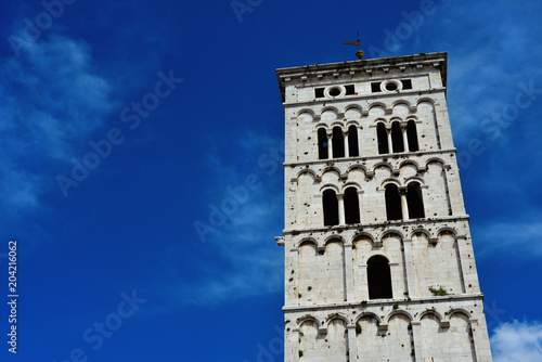 Saint Micheal in Foro Church medieval romanesque bell tower, erected in the 13th century in the city of Lucca, Tuscany (with blue sky and copy space)