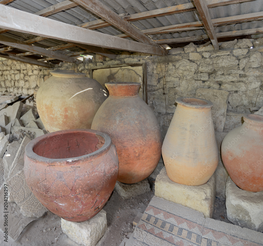 Several ancient pithos under shade port in Chersonesus, Sevastopol, Crimea. Several ancient pithos under shade port in Chersonesus, Sevastopol, Crimea.