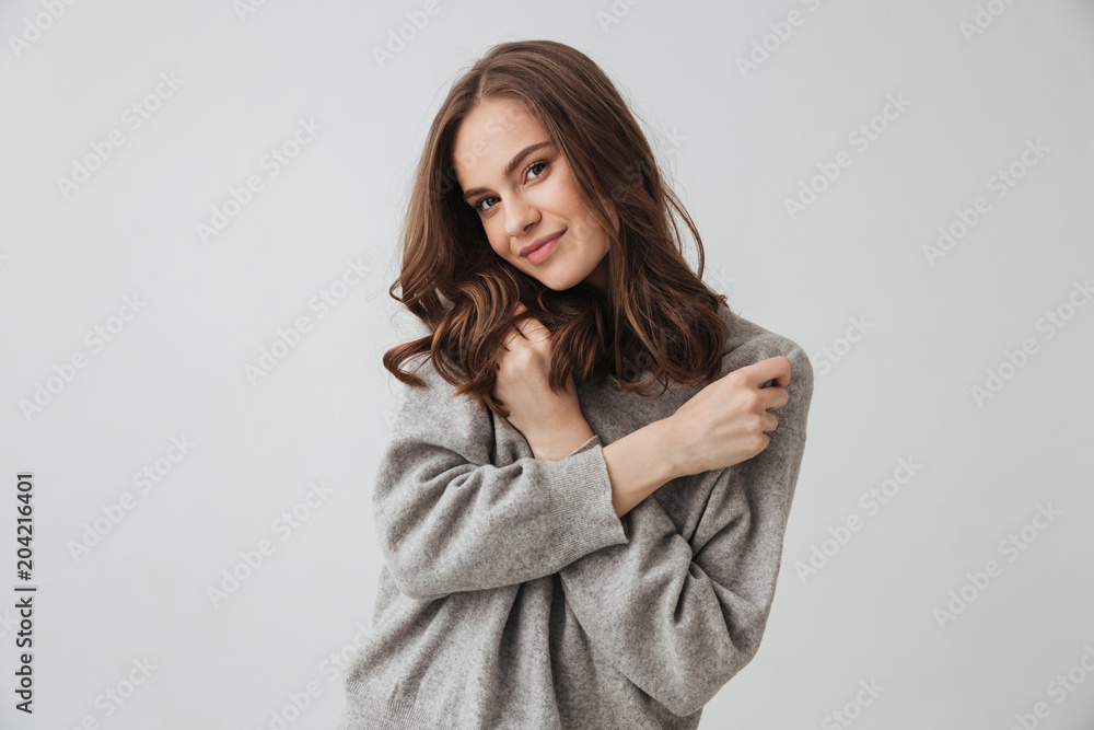 Pleased brunette woman in sweater posing with crossed arms Pleased brunette woman in sweater posing with crossed arms