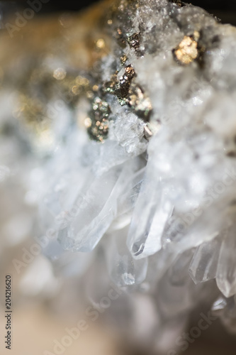 Background with crystal of translucent rock and golden ore