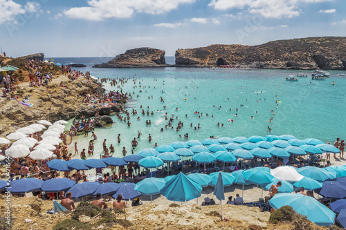 Принти на полотні Comino Island, Malta Blue Lagoon panoramic landscape with bathers and sun umbrellas