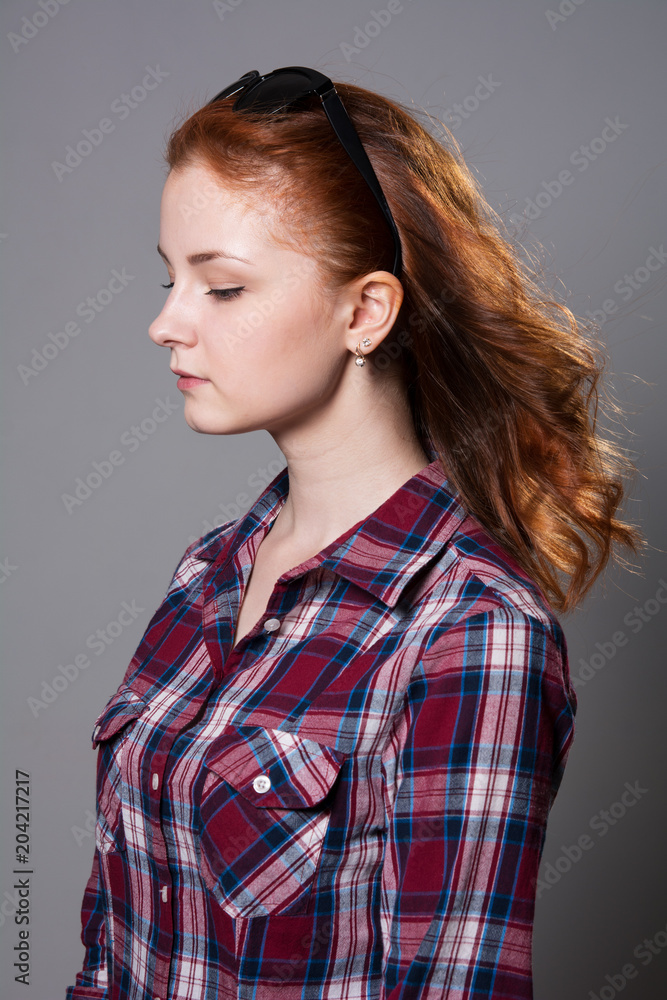 Portrait of a girl profile with dark glasses on her head looking down Portrait of a girl profile with dark glasses on her head looking down