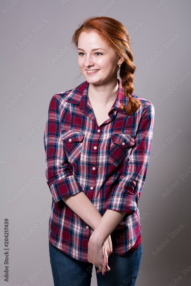 Portrait of a smiling young woman in a plaid shirt Portrait of a smiling young woman in a plaid shirt