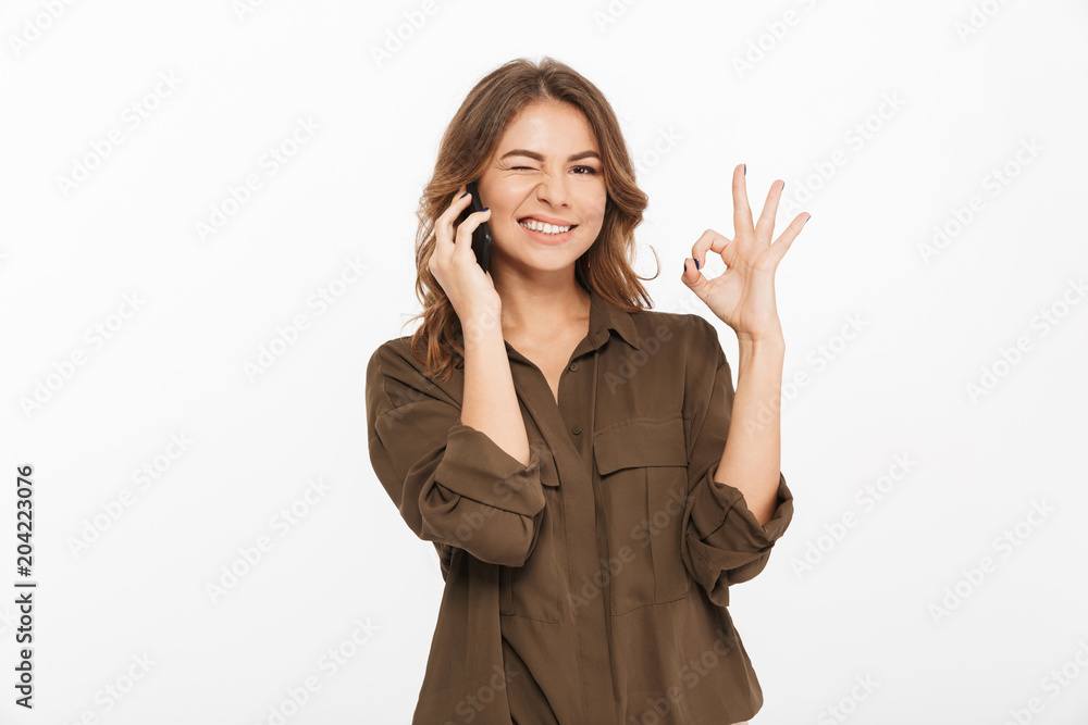 Portrait of a smiling young woman talking on mobile phone Portrait of a smiling young woman talking on mobile phone